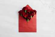 red envelope with fresh red flowers inside